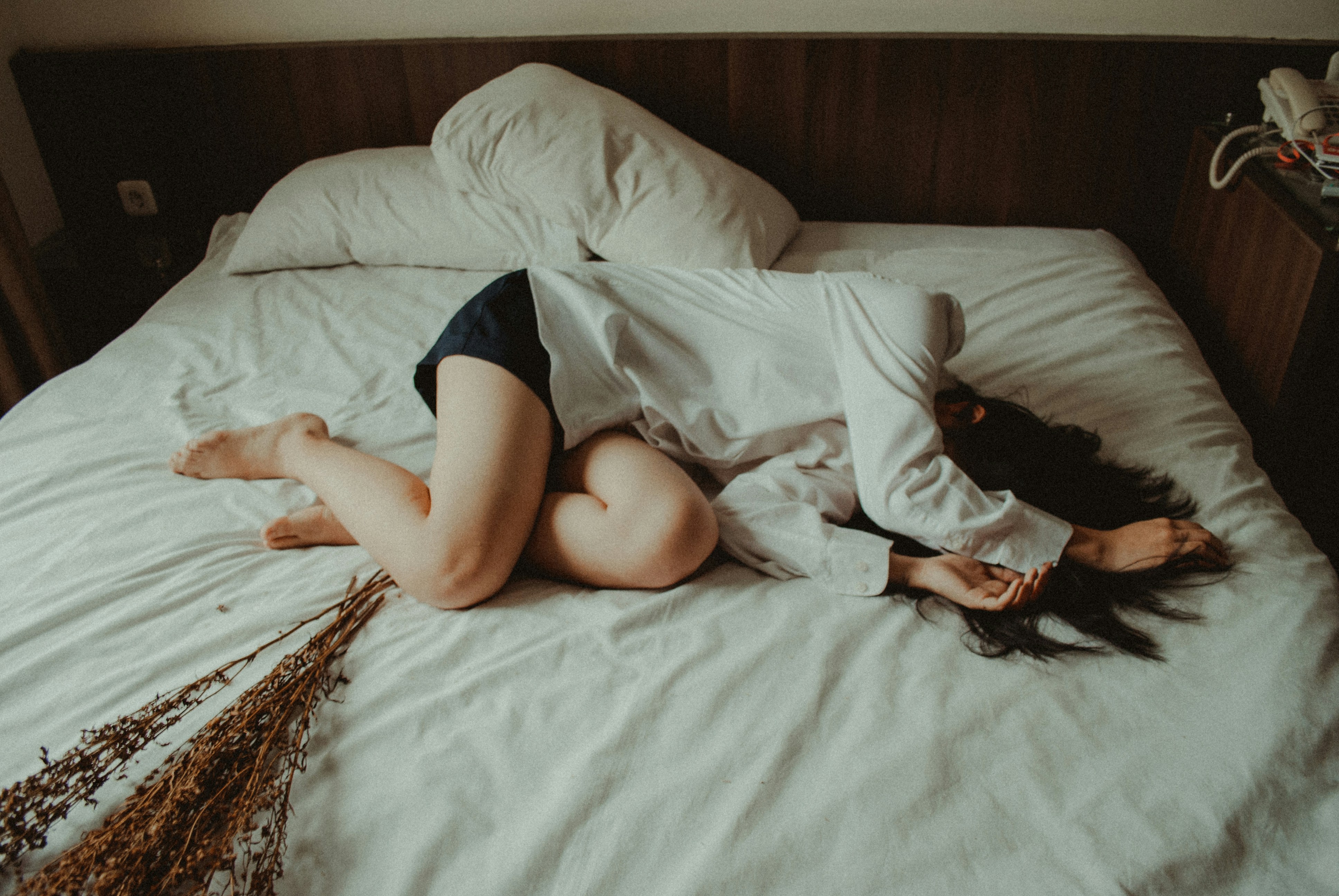 Narcissistic abuse - image of woman curled up laying on a bed