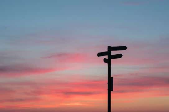 Cognitive behaviour therapy - image of direction sign with a sunrise in the background