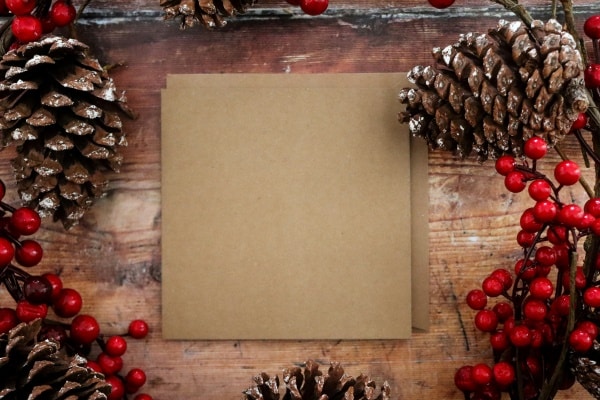Coping with Challenges During the Holidays - image of kraft paper surrounded by Christmas decorations on a wooden table